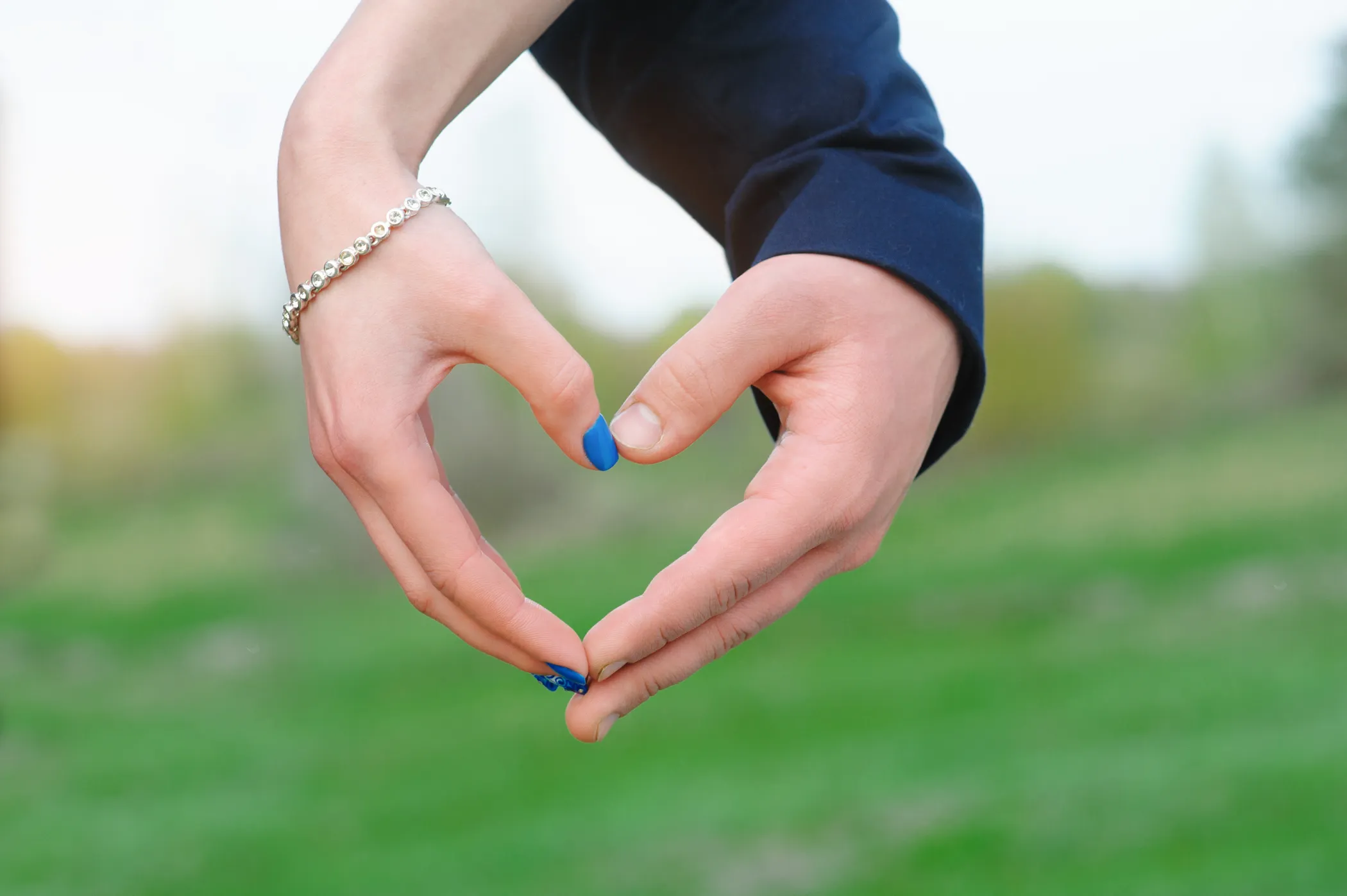 couple make a heart with hands
