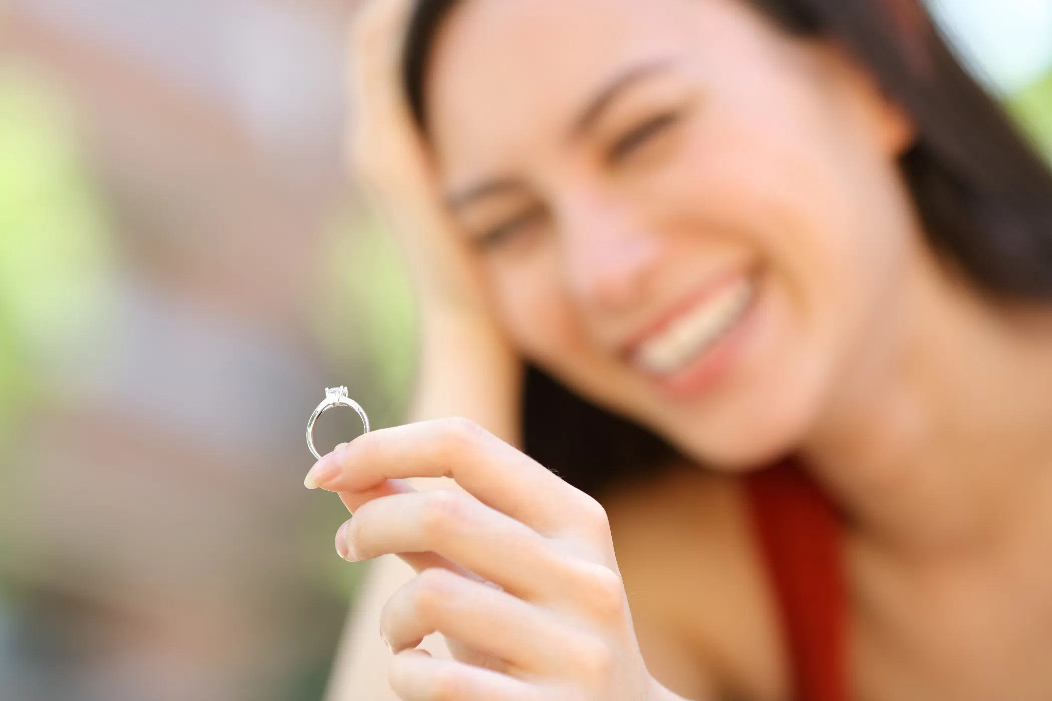 happy woman admiring engagement ring