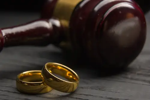 Two golden wedding rings, judge gavel.