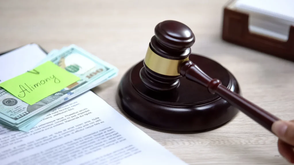 Dollars with alimony sign table, gavel