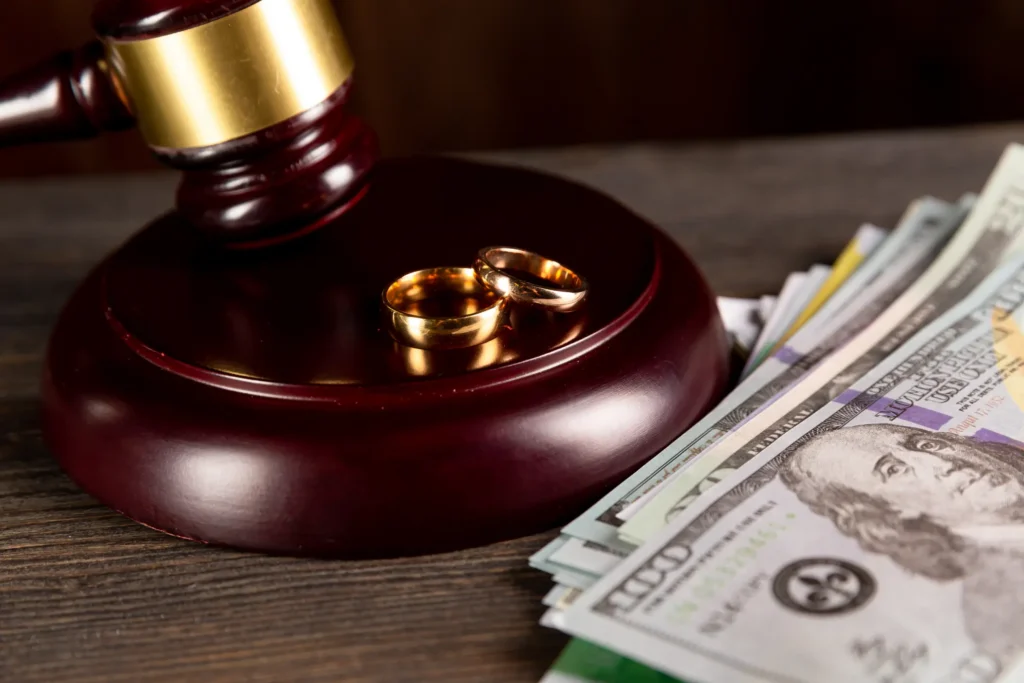 divorce attorney deferred compensation concept with rings gavel paper money