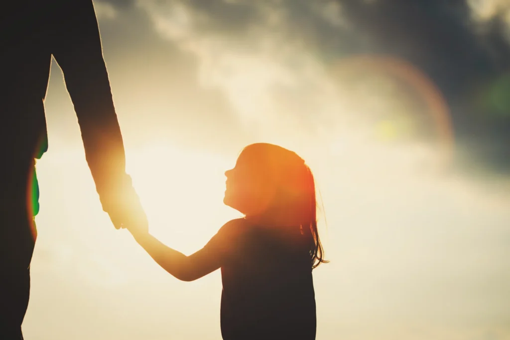 shadows of child and parent holding hands in bellevue child support case
