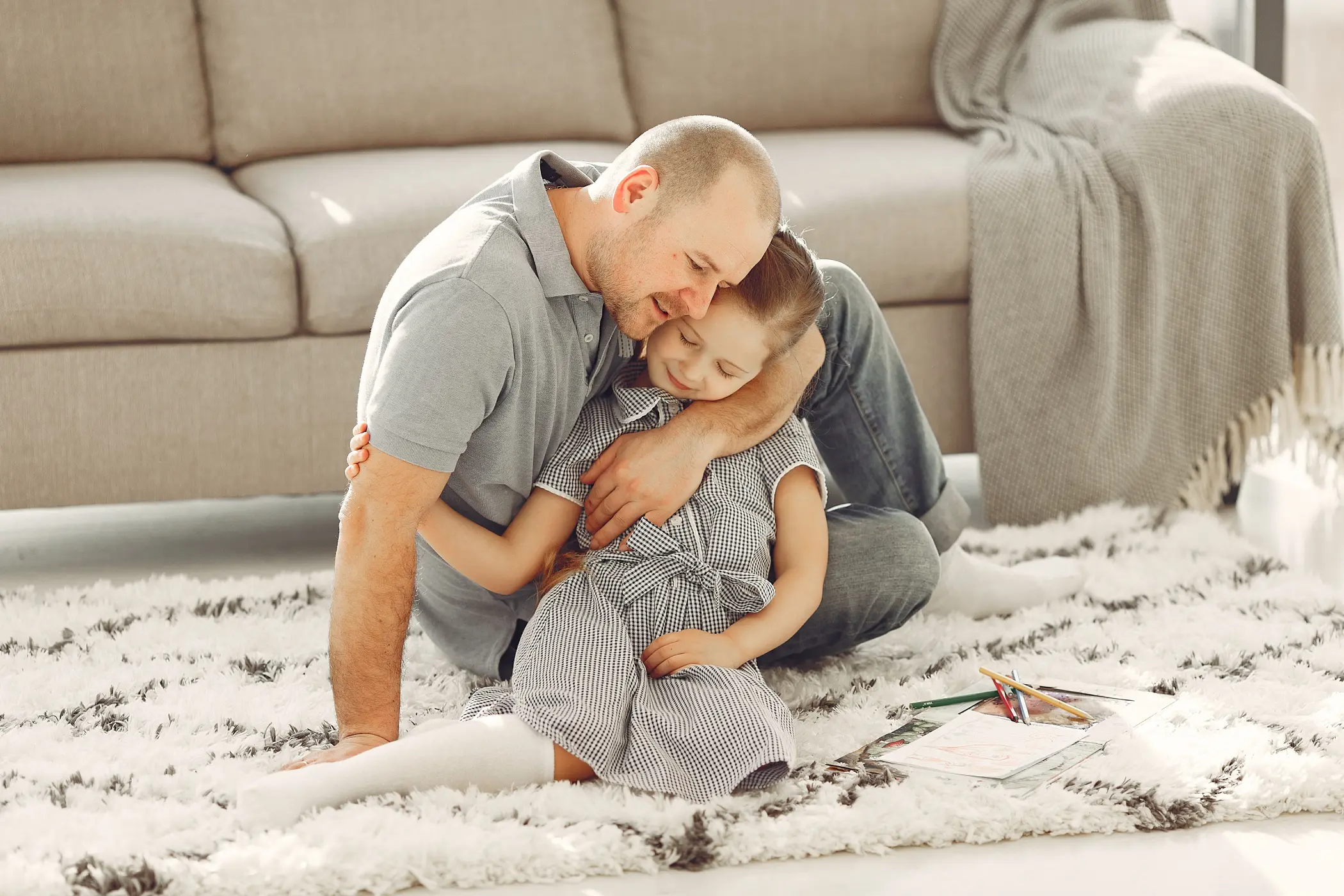 father comforts child after relocation move concept